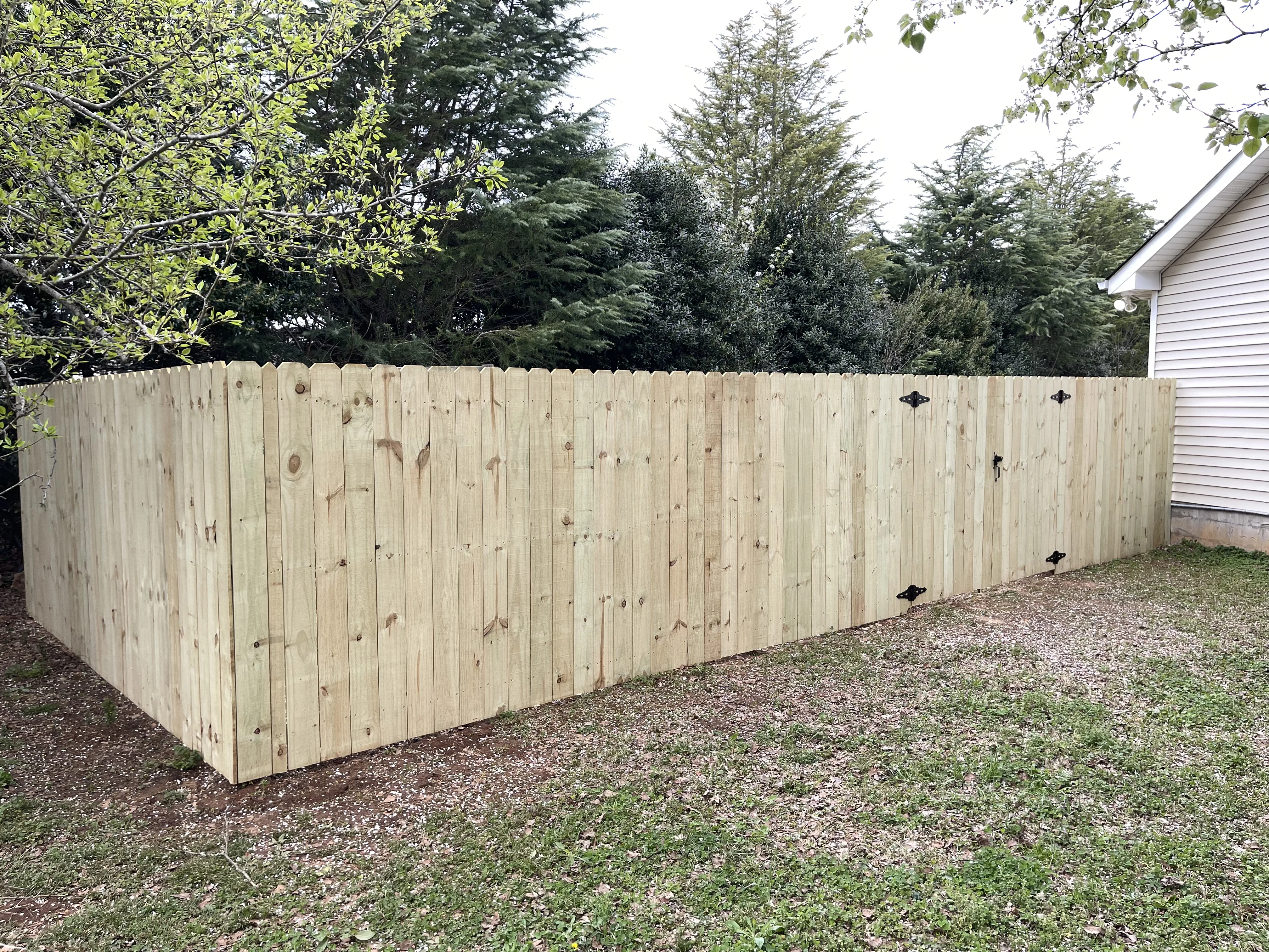 Wood privacy fence installation with gate